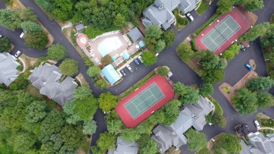 Drone view of the tennis courts, pool, spa and pavillion